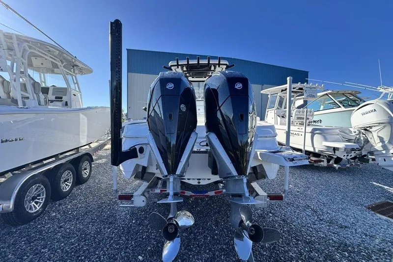 Slide: The Image of 2026 Caymas 281 HB boat with dual outboard motors in a marina setting. - 4