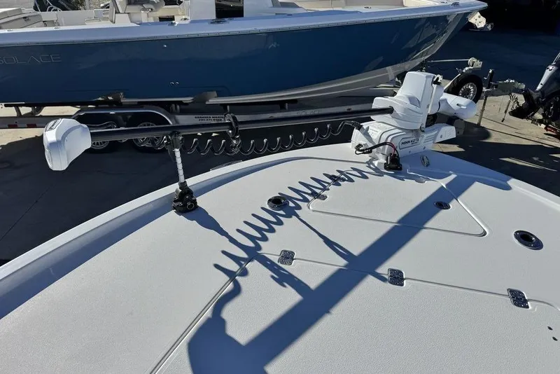 Slide: The Image of 2026 Caymas 281 HB boat deck with trolling motor, docked beside another boat. - 8