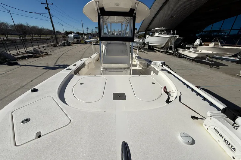 Slide: The Image of 2020 Tideline 235 Hybrid boat, spacious deck, docked outdoors, featuring Minn Kota trolling motor. - 11