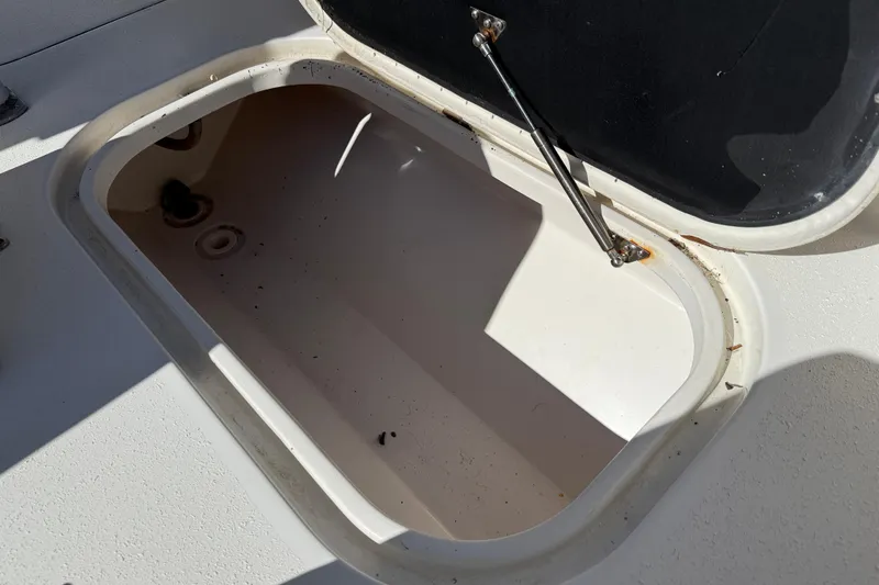 Slide: The Image of Open storage compartment on 2020 Tideline 235 Hybrid boat, showing interior details. - 19