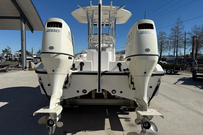 Slide: The Image of 2020 Tideline 235 Hybrid boat with dual 200 HP outboard engines, docked outdoors. - 6