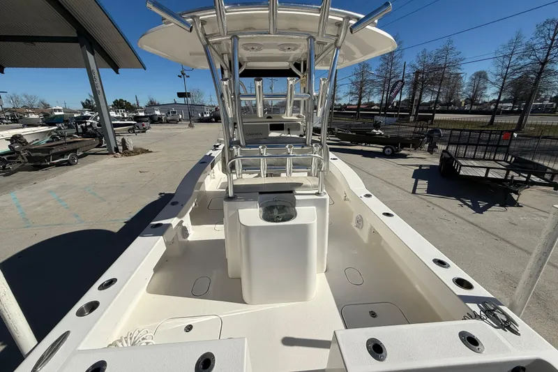 Slide: The Image of 2020 Tideline 235 Hybrid boat with center console and rod holders in a marina setting. - 8