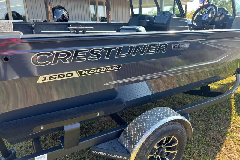 Slide: The Image of 2026 Crestliner 1650 Hawk boat on trailer, side view with logo and details. - 1