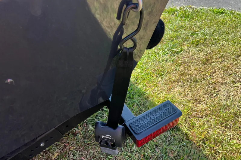 Slide: The Image of 2026 Crestliner 1650 Hawk trailer with Shortland strap on grassy surface. - 17