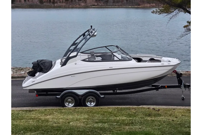 The Image of 2017 Yamaha Boats 212 Limited S on trailer by a lake. - 0