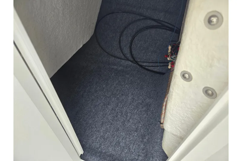 Slide: The Image of Interior storage compartment of 2017 Yamaha Boats 212 Limited S with visible wiring. - 16