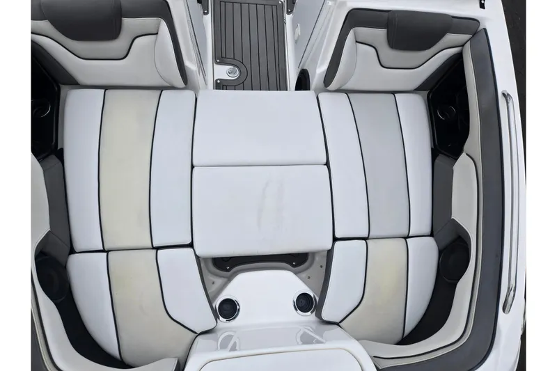 Slide: The Image of 2017 Yamaha Boats 212 Limited S interior seating, featuring sleek white and gray upholstery. - 20