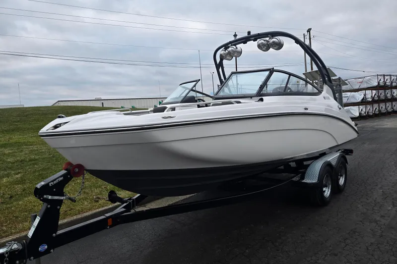 Slide: The Image of 2017 Yamaha Boats 212 Limited S on trailer, parked outdoors. - 5