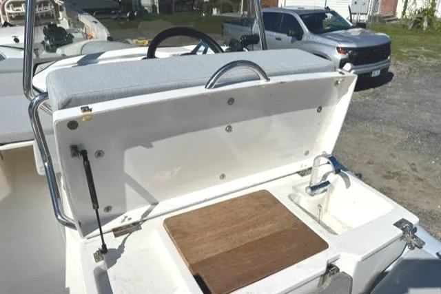 Slide: The Image of 2023 Zodiac N-ZO 680 boat with open storage compartment and sink on deck. - 10