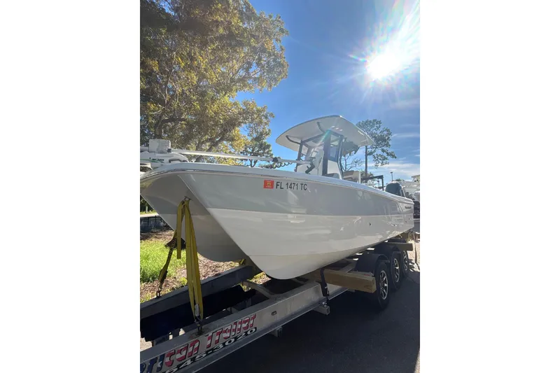 The Image of 2022 World Cat 235 CC boat on trailer under bright sunlight. - 0