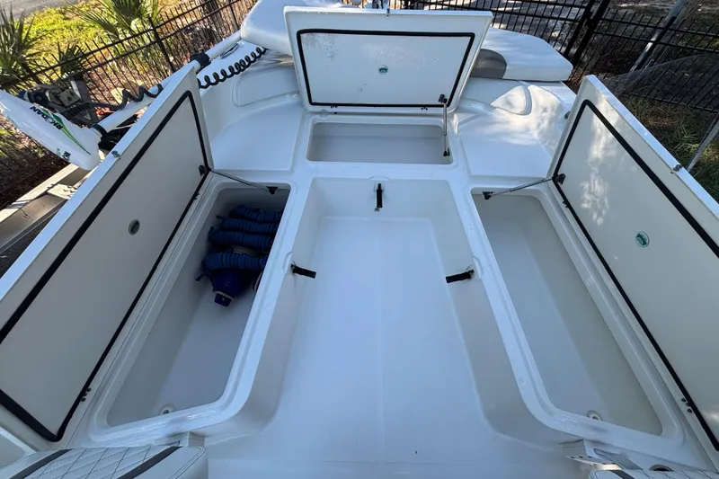 Slide: The Image of Open storage compartments on a 2022 World Cat 235 CC boat deck. - 10