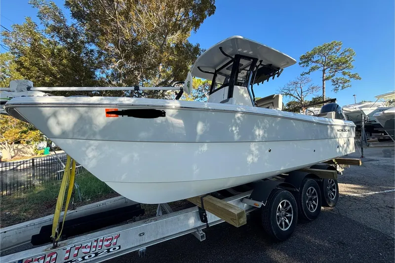 Slide: The Image of 2022 World Cat 235 CC boat on a trailer, parked outdoors. - 3