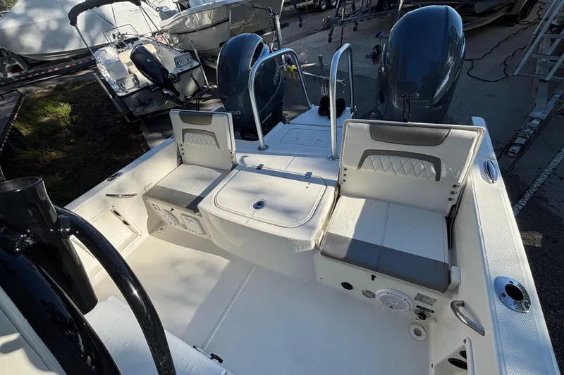 Slide: The Image of 2022 World Cat 235 CC boat interior with seating and dual engines. - 6