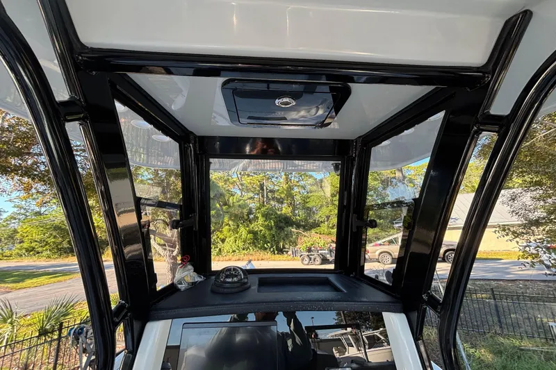 Slide: The Image of Interior view of 2022 World Cat 235 CC boat with clear windows and sleek design. - 9