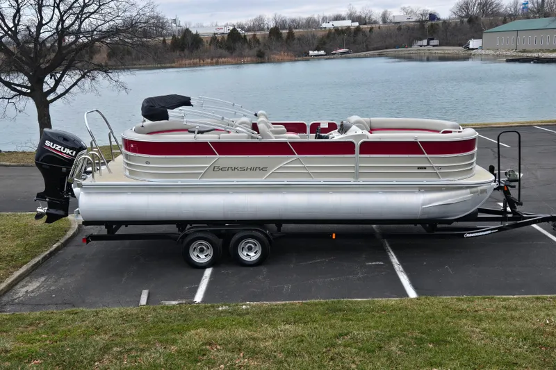 The Image of 2008 Berkshire CPT 24 RFX pontoon boat on trailer by a lake. - 0