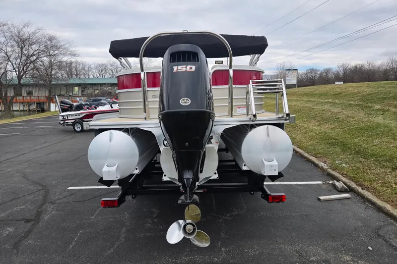 Slide: The Image of 2008 Berkshire CPT 24 RFX pontoon boat with 150 HP engine, parked outdoors. - 2