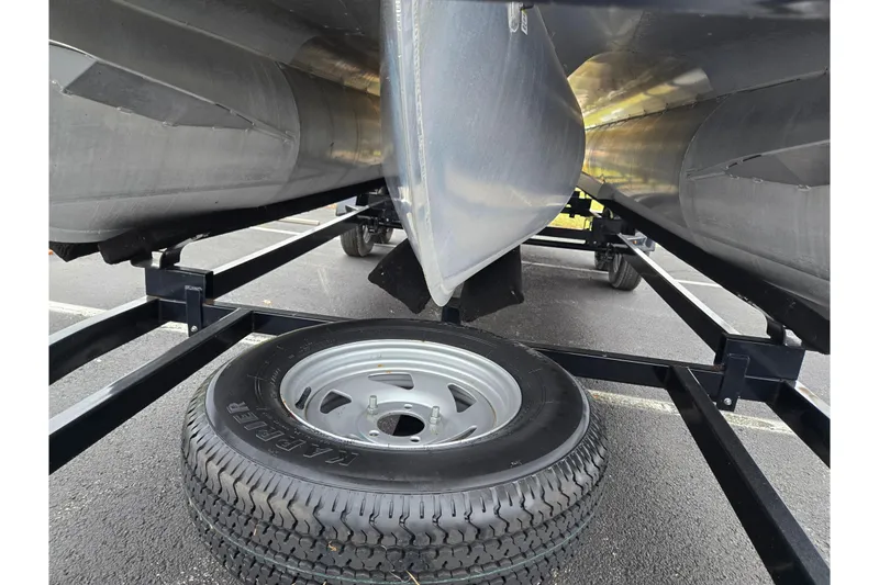 Slide: The Image of Underneath view of a 2008 Berkshire CPT 24 RFX boat on a trailer with spare tire. - 7