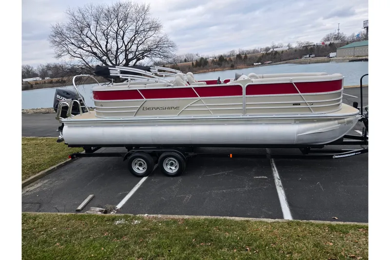Slide: The Image of 2008 Berkshire CPT 24 RFX pontoon boat on trailer by a lake. - 9