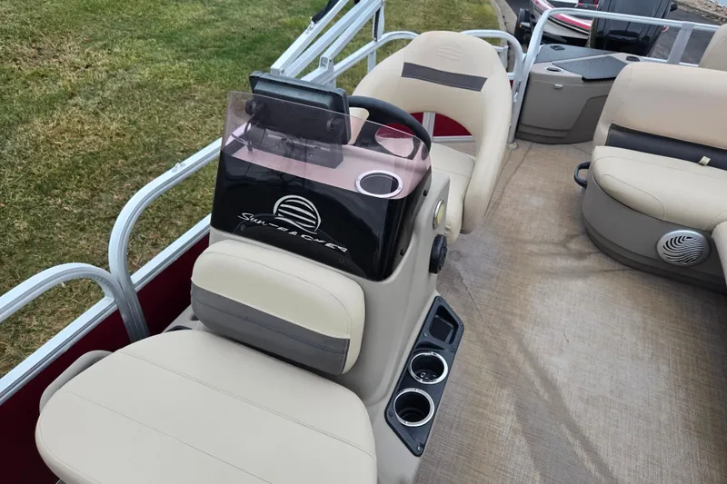 Slide: The Image of 2020 Sun Tracker Bass Buggy 18 DLX interior with beige seating and steering console. - 13