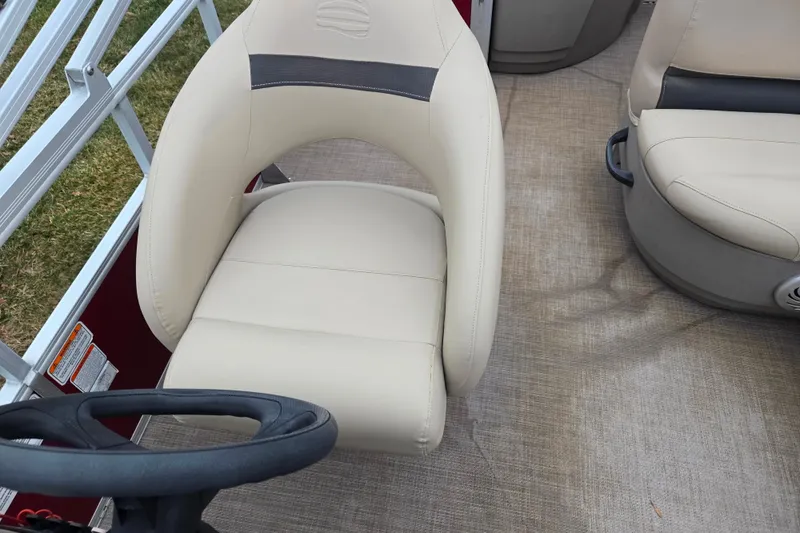 Slide: The Image of 2020 Sun Tracker Bass Buggy 18 DLX interior with beige seating and steering wheel. - 15