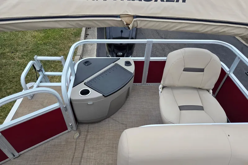 Slide: The Image of 2020 Sun Tracker Bass Buggy 18 DLX interior with seating and console. - 18