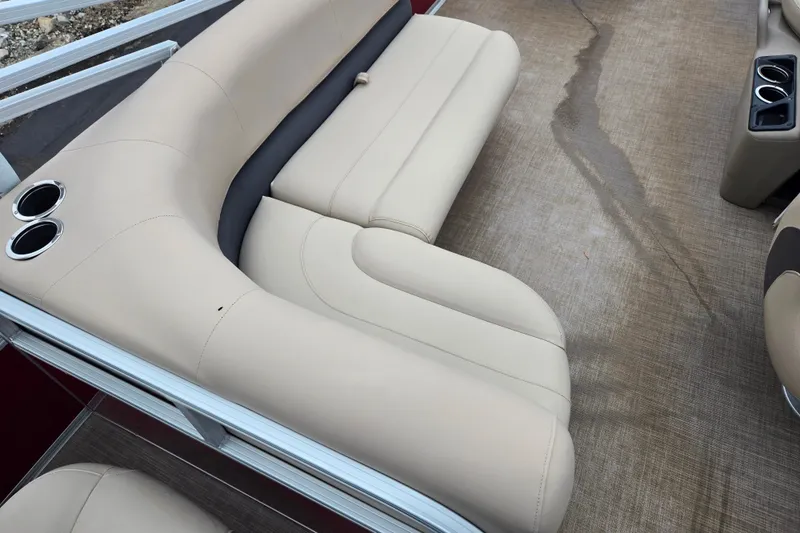 Slide: The Image of 2020 Sun Tracker Bass Buggy 18 DLX boat interior with beige seating and cup holders. - 20