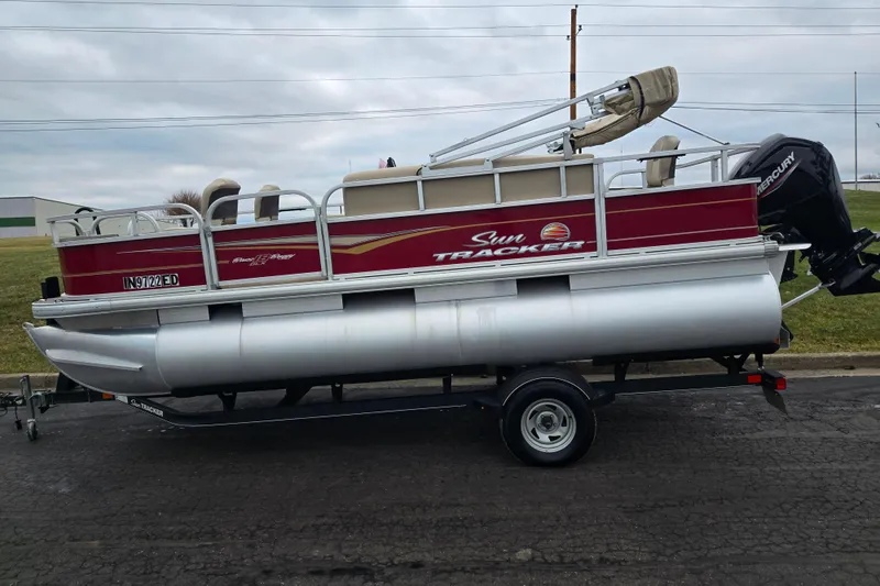 Slide: The Image of 2020 Sun Tracker Bass Buggy 18 DLX pontoon boat on trailer, side view. - 4