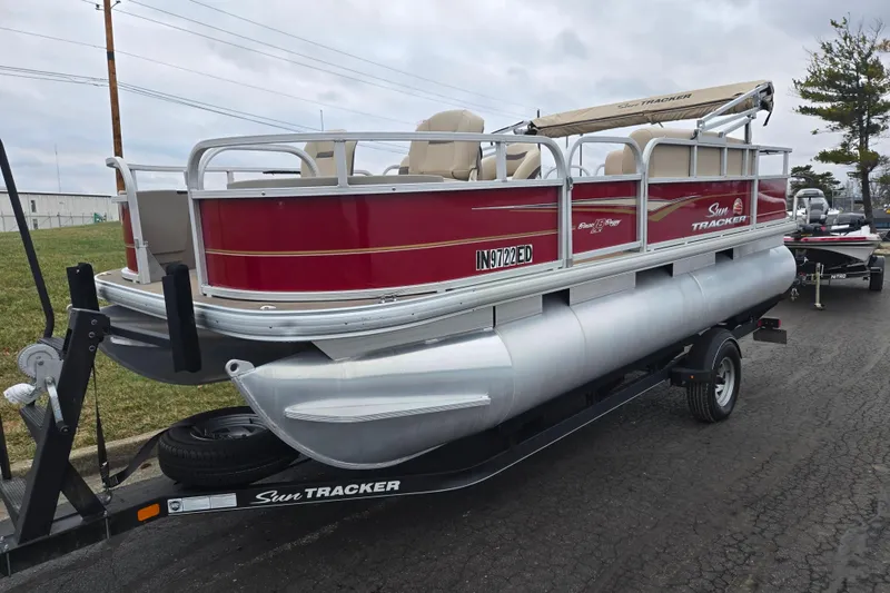 Slide: The Image of 2020 Sun Tracker Bass Buggy 18 DLX pontoon boat on trailer, red and silver design. - 5