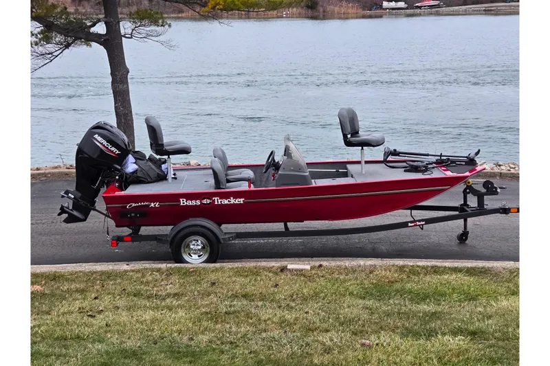 The Image of 2024 Tracker Bass Tracker Classic XL boat on trailer by a lake. - 0