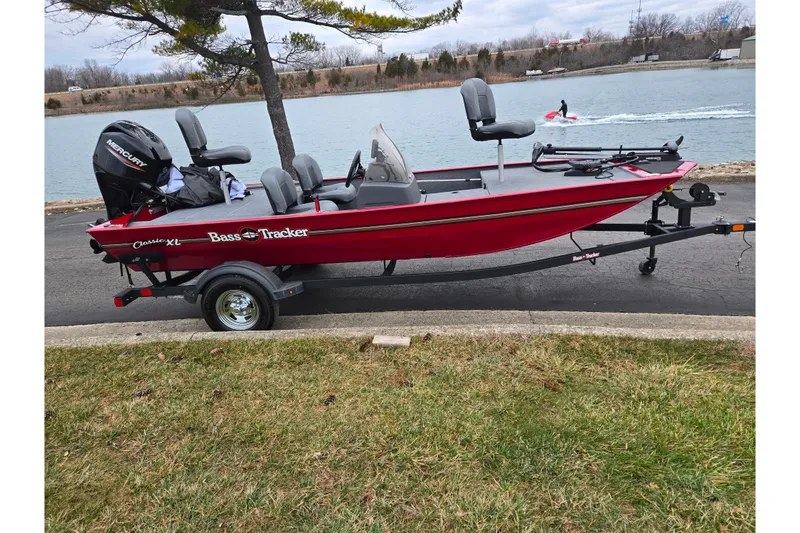 Slide: The Image of 2024 Tracker Bass Tracker Classic XL boat on trailer by a lake. - 10