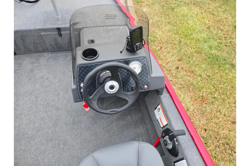 Slide: The Image of 2024 Tracker Bass Tracker Classic XL boat console with steering wheel and controls. - 12