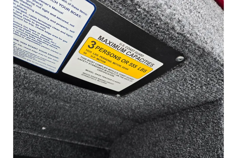 Slide: The Image of 2024 Tracker Bass Tracker Classic XL capacity label, 3 persons or 555 lbs, U.S. Coast Guard compliant. - 13