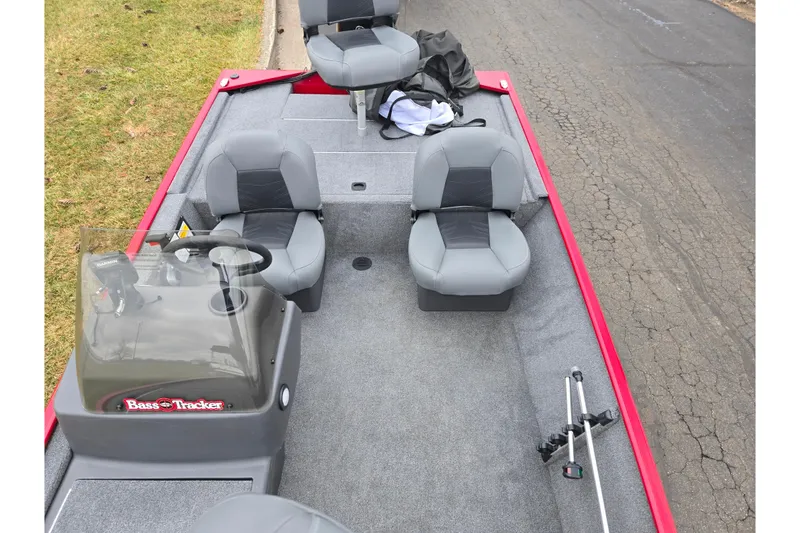 Slide: The Image of 2024 Tracker Bass Tracker Classic XL boat interior with gray seats and steering console. - 19