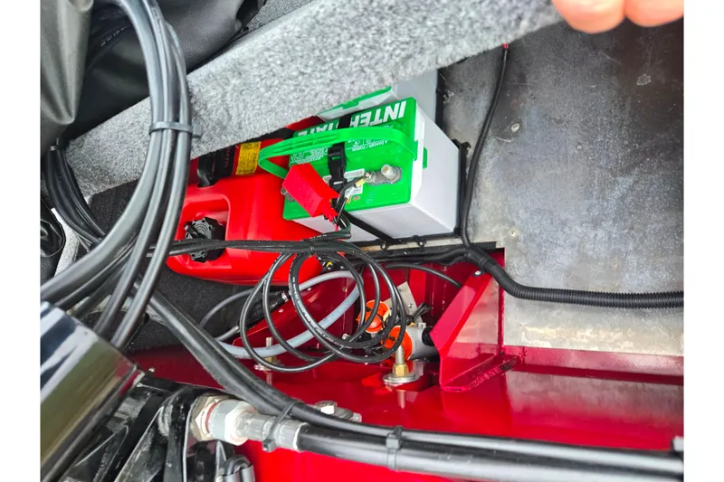 Slide: The Image of 2024 Tracker Bass Tracker Classic XL battery compartment with wiring and components. - 23