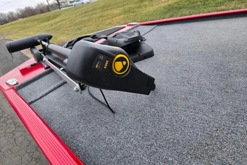 Slide: The Image of 2024 Tracker Bass Tracker Classic XL with trolling motor on carpeted deck. - 5