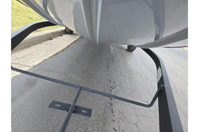 Slide: The Image of 2024 Tracker Bass Tracker Classic XL boat on trailer, close-up view of hull and pavement. - 8