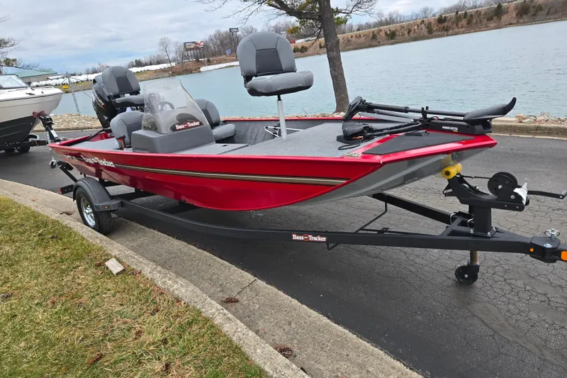 Slide: The Image of 2024 Tracker Bass Tracker Classic XL boat on trailer by a lake. - 9