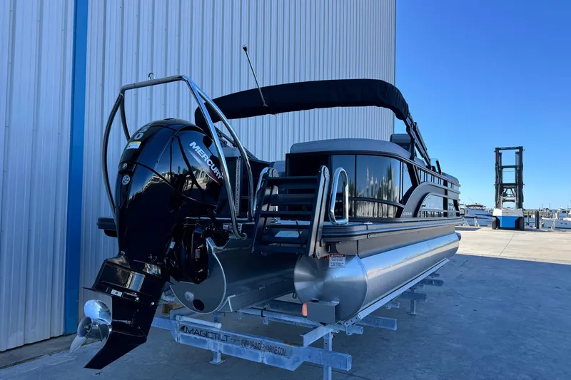 Slide: The Image of 2026 Bennington 22 SSR pontoon boat with Mercury engine, docked outdoors. - 4