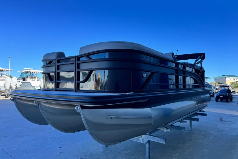 Slide: The Image of 2026 Bennington 22 SSR pontoon boat on display under clear blue sky. - 6