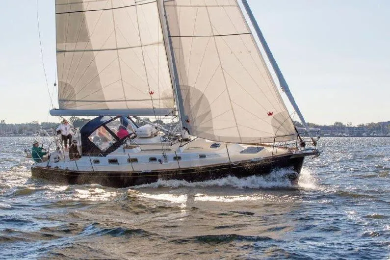 The Image of 2019 Tartan 395 sailboat navigating on open water with full sails. - 0