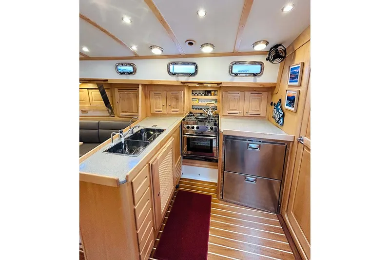 Slide: The Image of Luxurious 2019 Tartan 395 yacht interior kitchen with modern appliances and wooden cabinetry. - 10