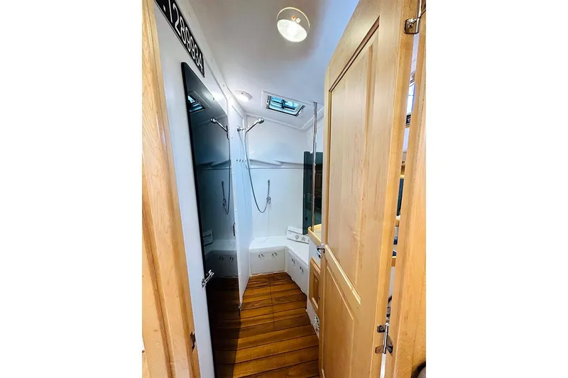 Slide: The Image of 2019 Tartan 395 yacht bathroom with wooden flooring and modern fixtures. - 11