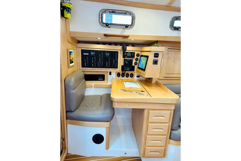 Slide: The Image of Navigation station in 2019 Tartan 395 yacht with control panels and seating. - 13