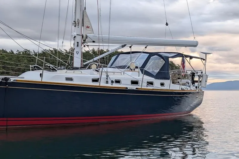 Slide: The Image of 2019 Tartan 395 sailboat on calm water, featuring sleek design and modern rigging. - 7