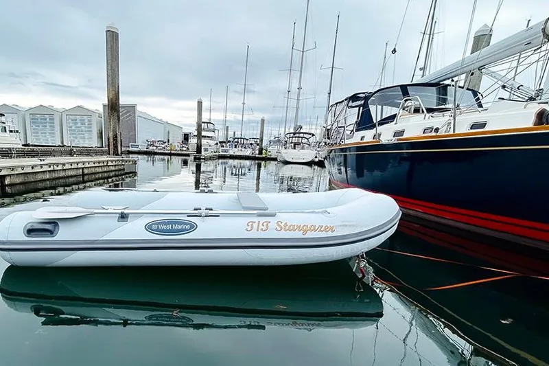 Slide: The Image of Inflatable boat "TIS Stargazer" docked near Tartan 395 yacht, 2019 model, in marina. - 8