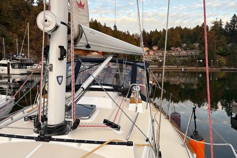 Slide: The Image of 2019 Tartan 395 sailboat docked in a scenic marina with forested backdrop. - 9