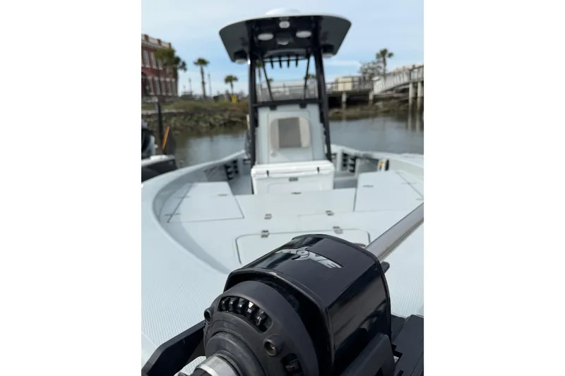 Slide: The Image of 2023 BlackJack 256 Bay boat on water, showcasing deck and console. - 6