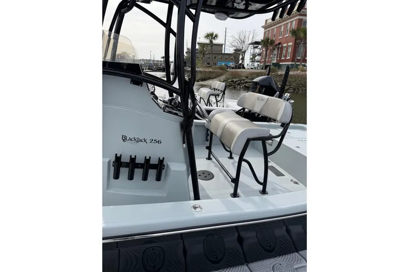 Slide: The Image of 2023 BlackJack 256 Bay boat interior with seating and rod holders. - 8
