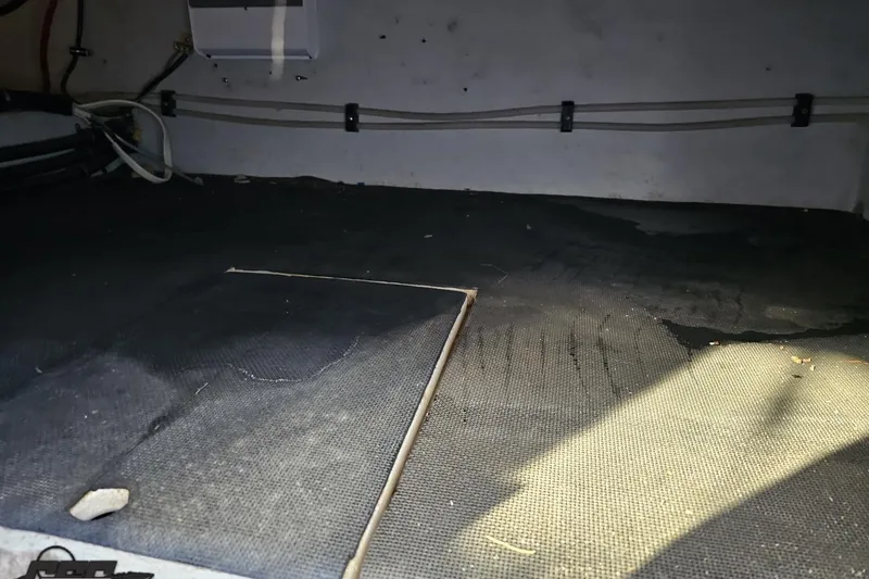 Slide: The Image of Interior of a 2000 Cobalt 293 boat showing floor and wiring details. - 102