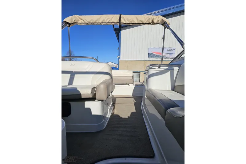 Slide: The Image of 2000 Cobalt 293 boat interior with seating and canopy under clear blue sky. - 104